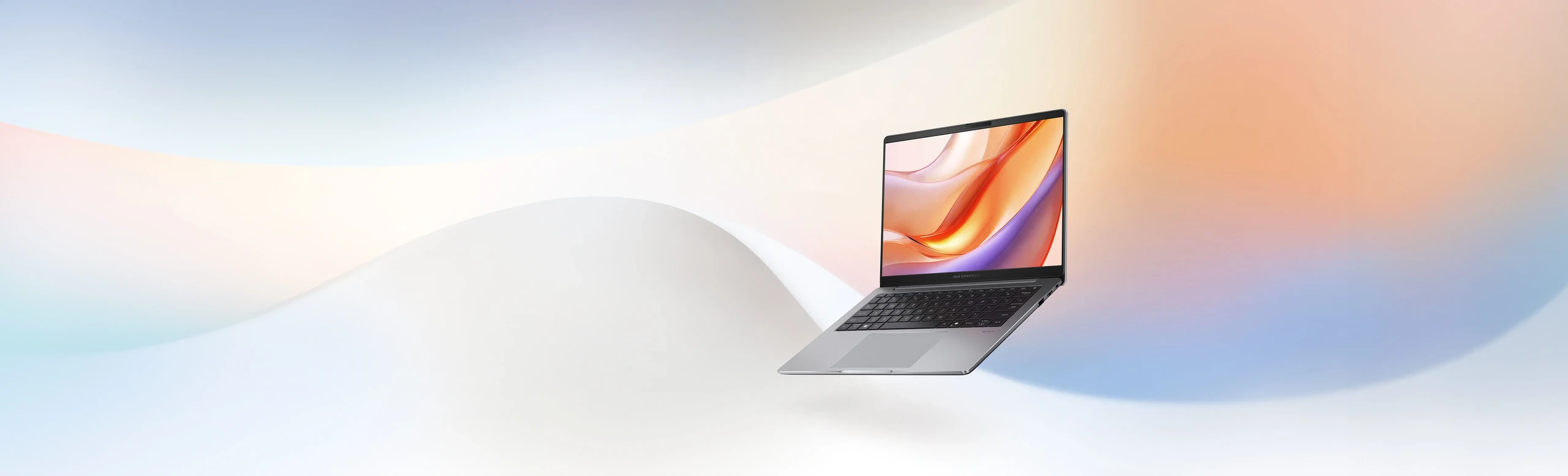 A silver ASUS ExpertBook P3 with an open screen floating against a colourful pastel-shaded background