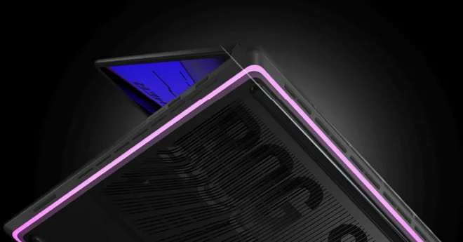 The bottom of an ROG Strix laptop with pink and blue lighting surrounding the chassis.