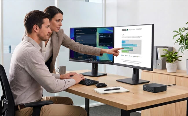 Two colleagues analyzing data with ASUS NUC 16 Pro